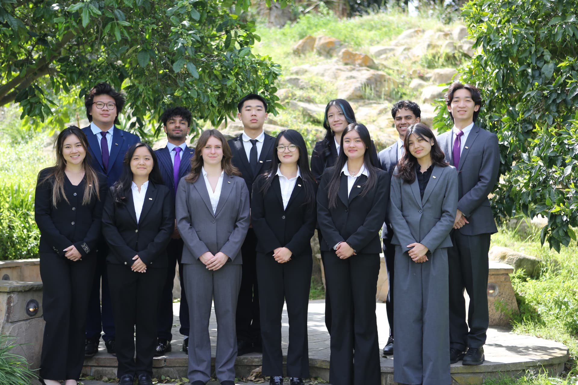Members of Phi Chi Theta at UC Irvine in business attire on campus